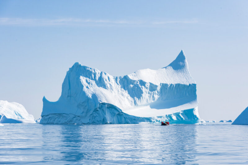Iceberg and Zodiac on an Arctic Icebreaker cruise PONANT