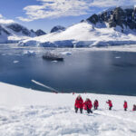 Le Austral expedition cruise ship with penguins in Antarctica