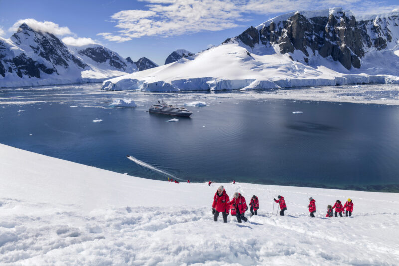 Le Austral expedition cruise ship with penguins in Antarctica