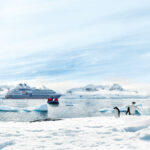Le Austral expedition cruise ship with penguins in Antarctica