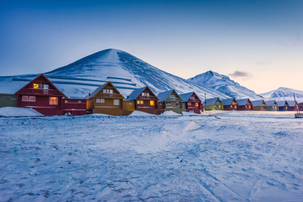A photo of Longyearbyen in Svalbard with snow on houses during the winter