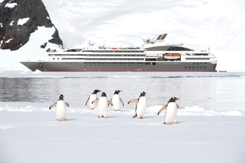 Le Austral expedition cruise ship with penguins in Antarctica