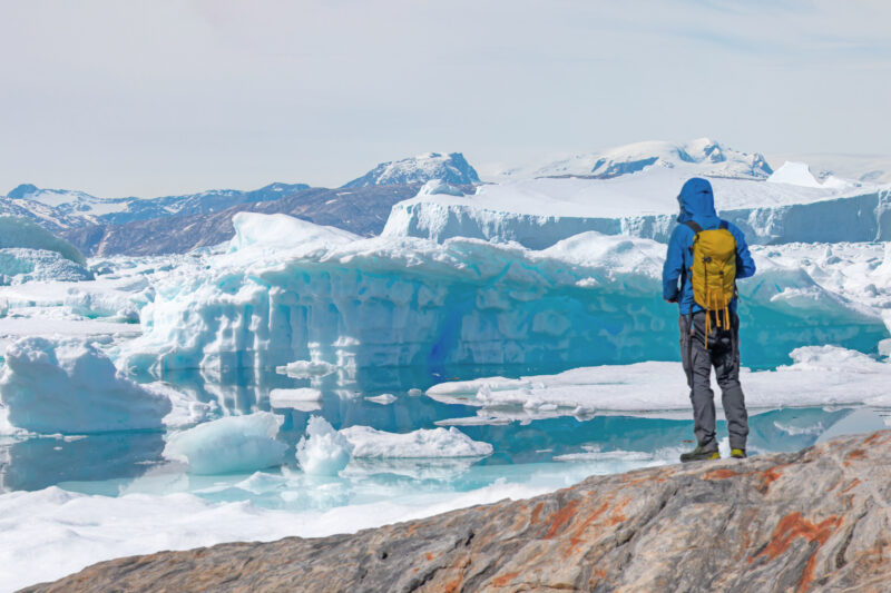 when to go to the Arctic man watching Icebergs in Greenland