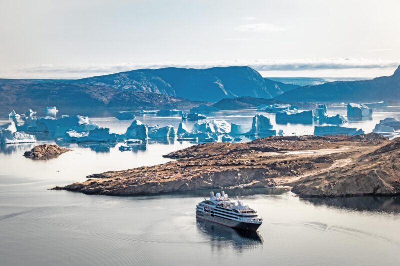 greenland cruise ship with icebergs in background